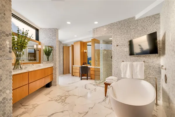 a bathroom with a bathtub and shower