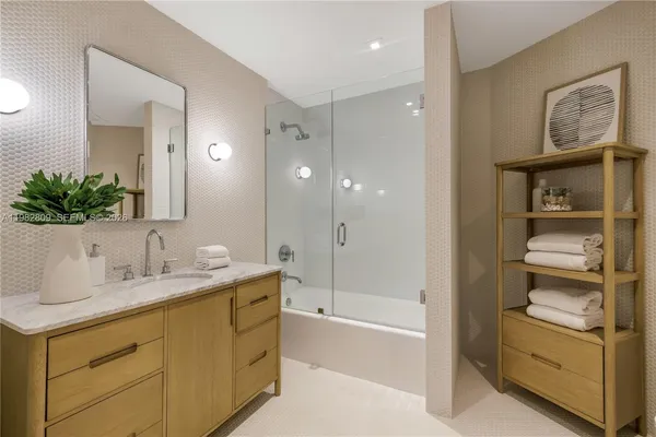 a bedroom with a large bed and a large window