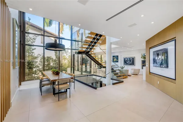 a living room with furniture fireplace and a large window