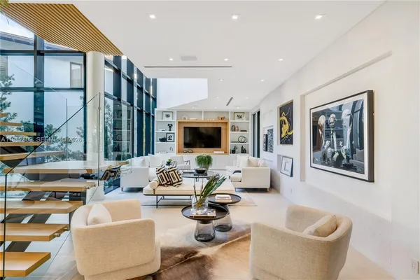 a view of living room with furniture and large windows