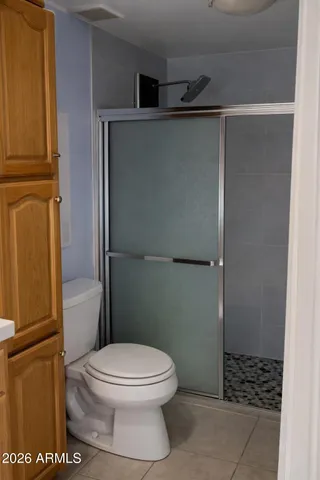 a bathroom with a toilet and a shower