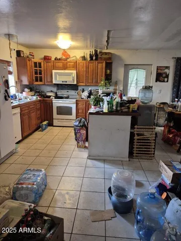 a kitchen with stainless steel appliances kitchen island granite countertop a stove and cabinets
