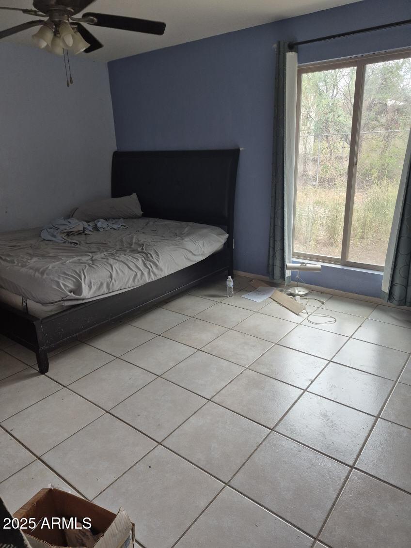 404 Calle Madrid Rio Rico, AZ 85648 - Photo 20 of 26 a bedroom with a bed and a window