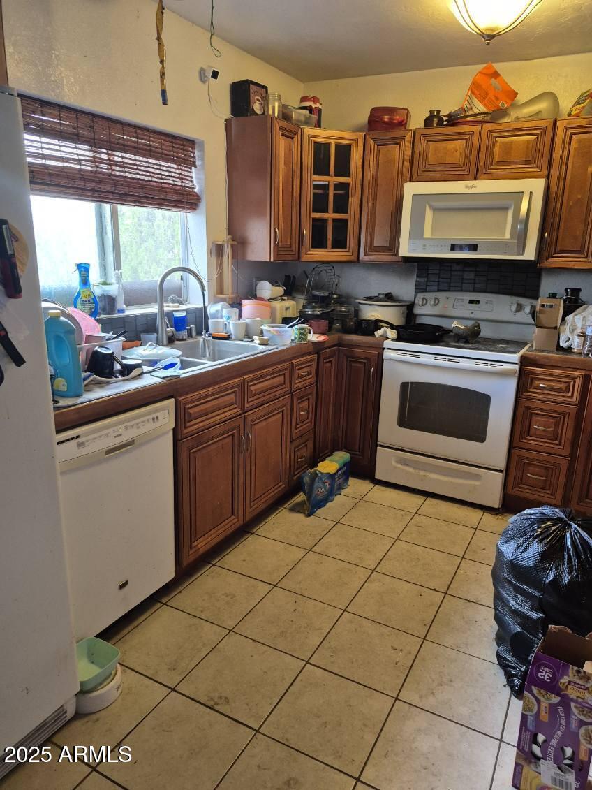404 Calle Madrid Rio Rico, AZ 85648 - Photo 8 of 26 a kitchen with stainless steel appliances a stove a sink and a microwave