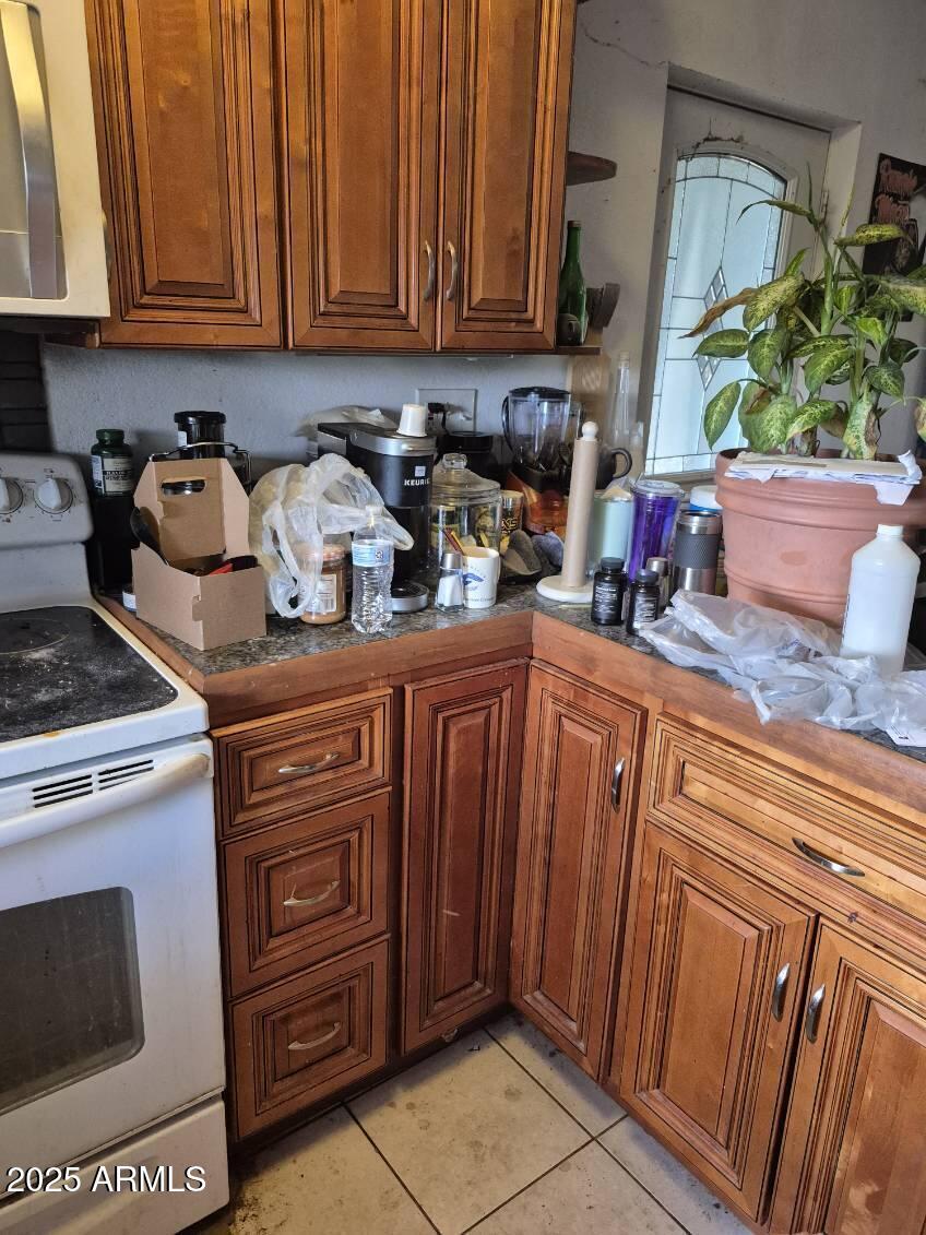404 Calle Madrid Rio Rico, AZ 85648 - Photo 9 of 26 a kitchen with stainless steel appliances granite countertop a stove a sink and a microwave