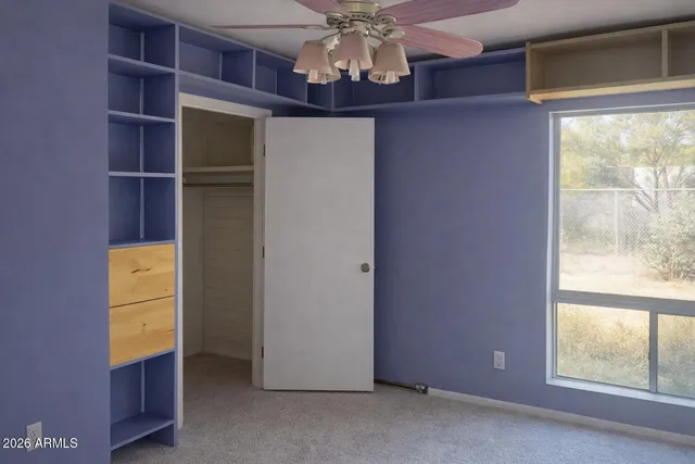 a view of room with window and cabinet