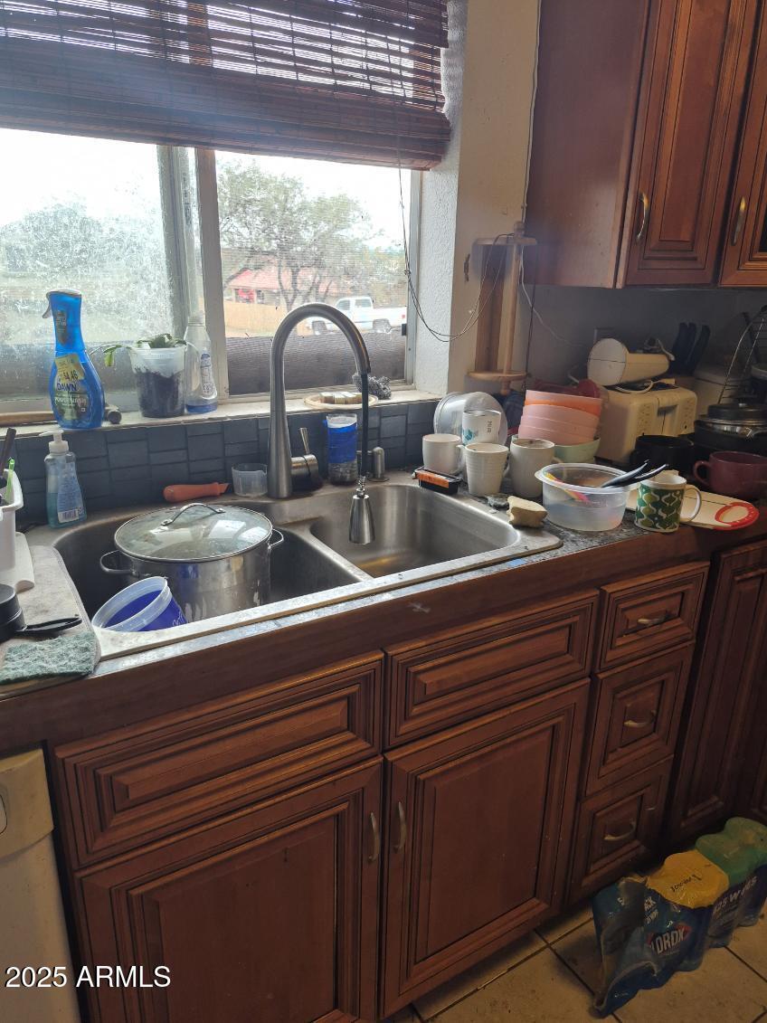 404 Calle Madrid Rio Rico, AZ 85648 - Photo 10 of 26 a kitchen with a sink and wooden cabinets