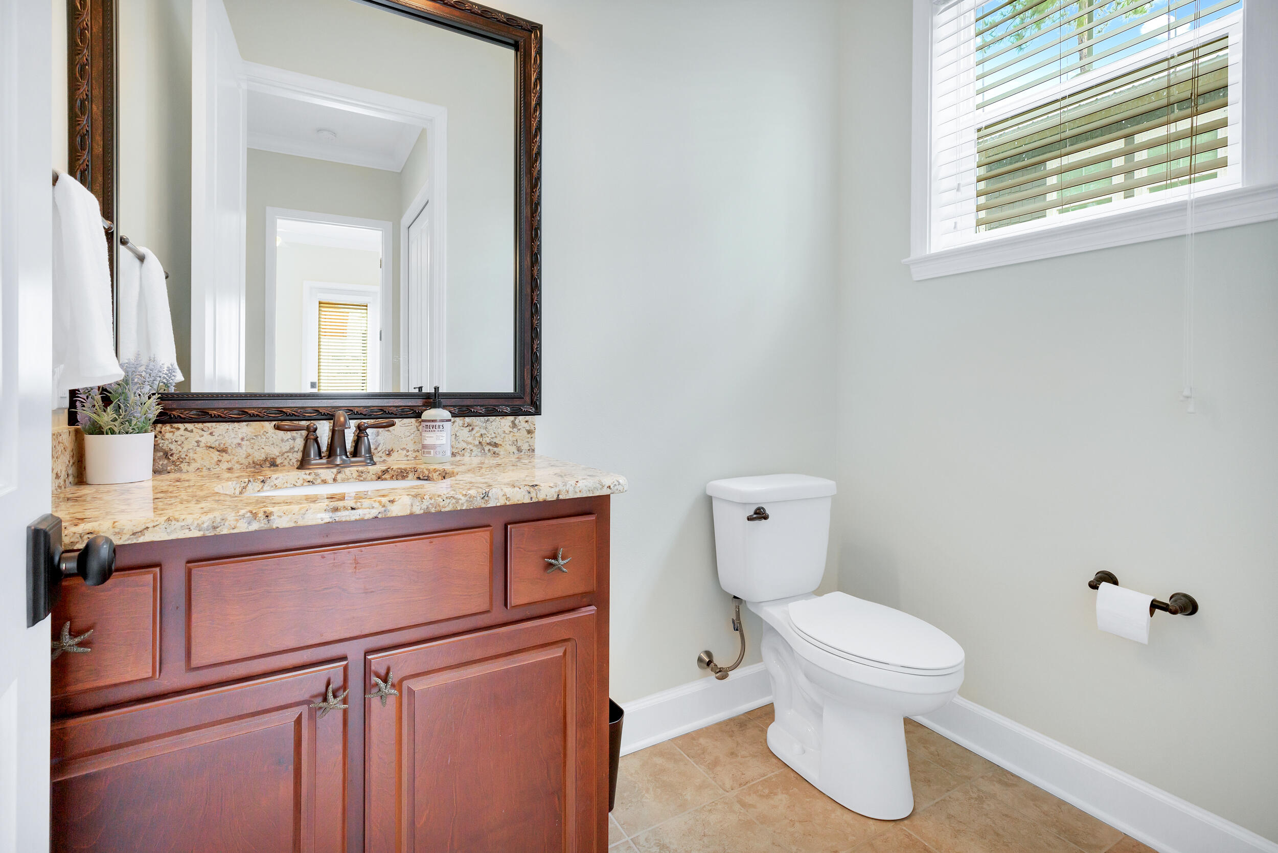 14 Crepe Myrtle Lane Santa Rosa Beach, FL 32459 - Photo 16 of 38 a bathroom with a granite countertop toilet sink and mirror