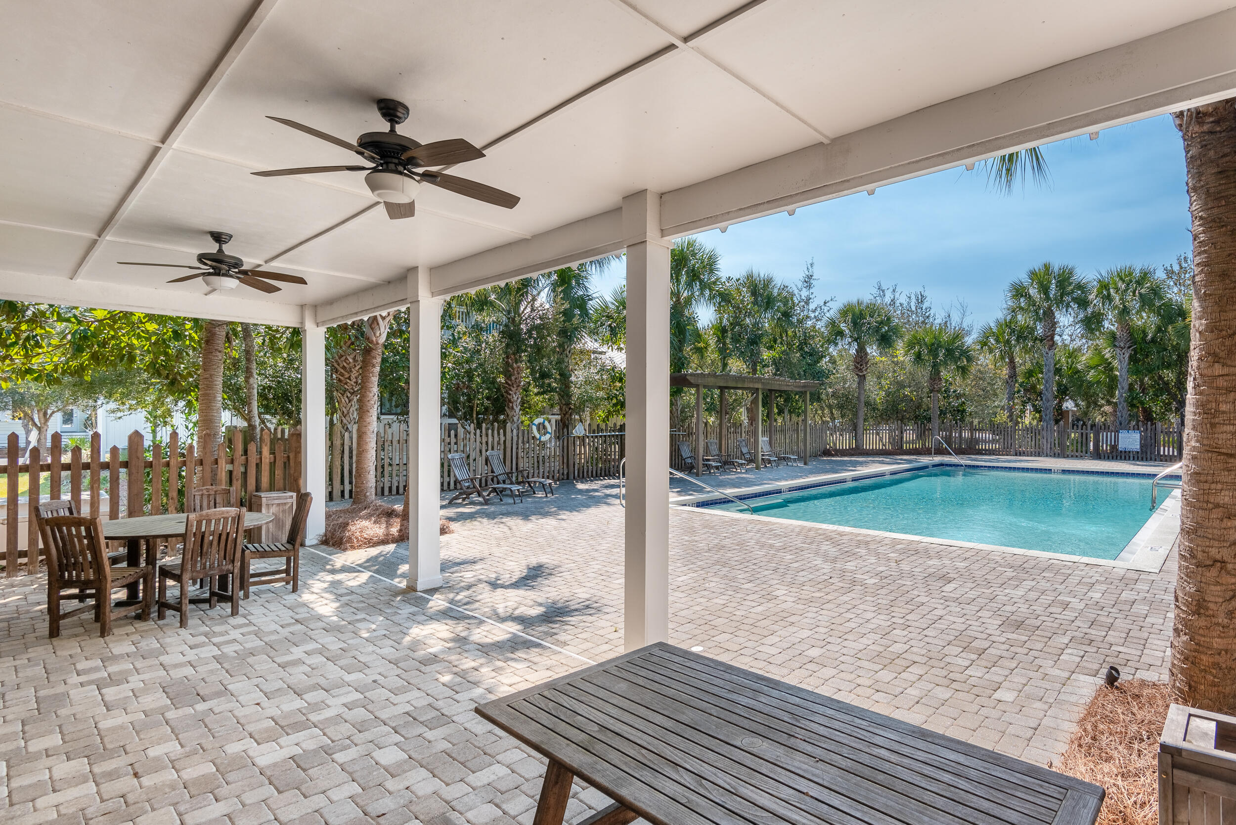 14 Crepe Myrtle Lane Santa Rosa Beach, FL 32459 - Photo 36 of 38 a view of a patio with a table chairs and a backyard
