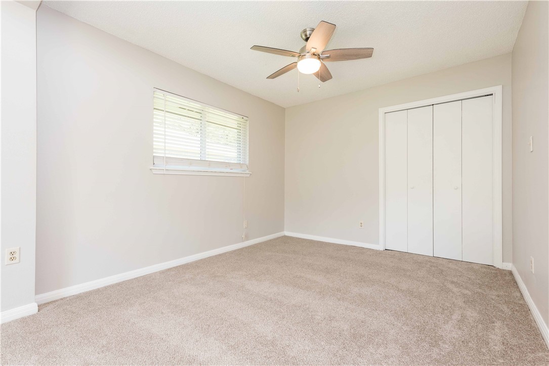 5505 Pendleton Lane Austin, TX 78723 - Photo 16 of 30 an empty room with a ceiling fan and a window