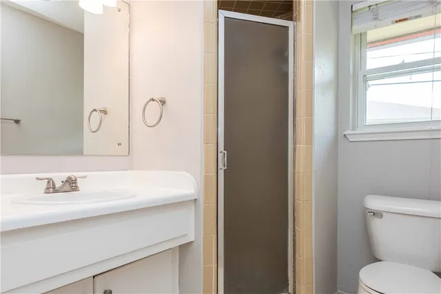 a bathroom with a sink toilet and a mirror