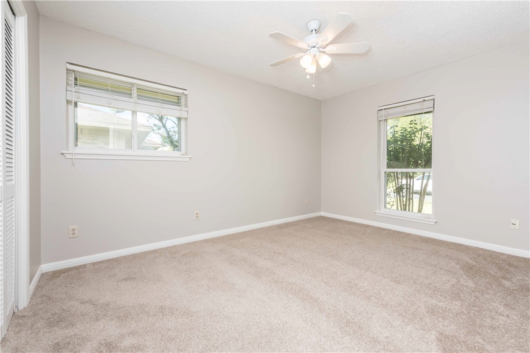 5505 Pendleton Lane Austin, TX 78723 - Photo 22 of 30 an empty room with a window and a ceiling fan