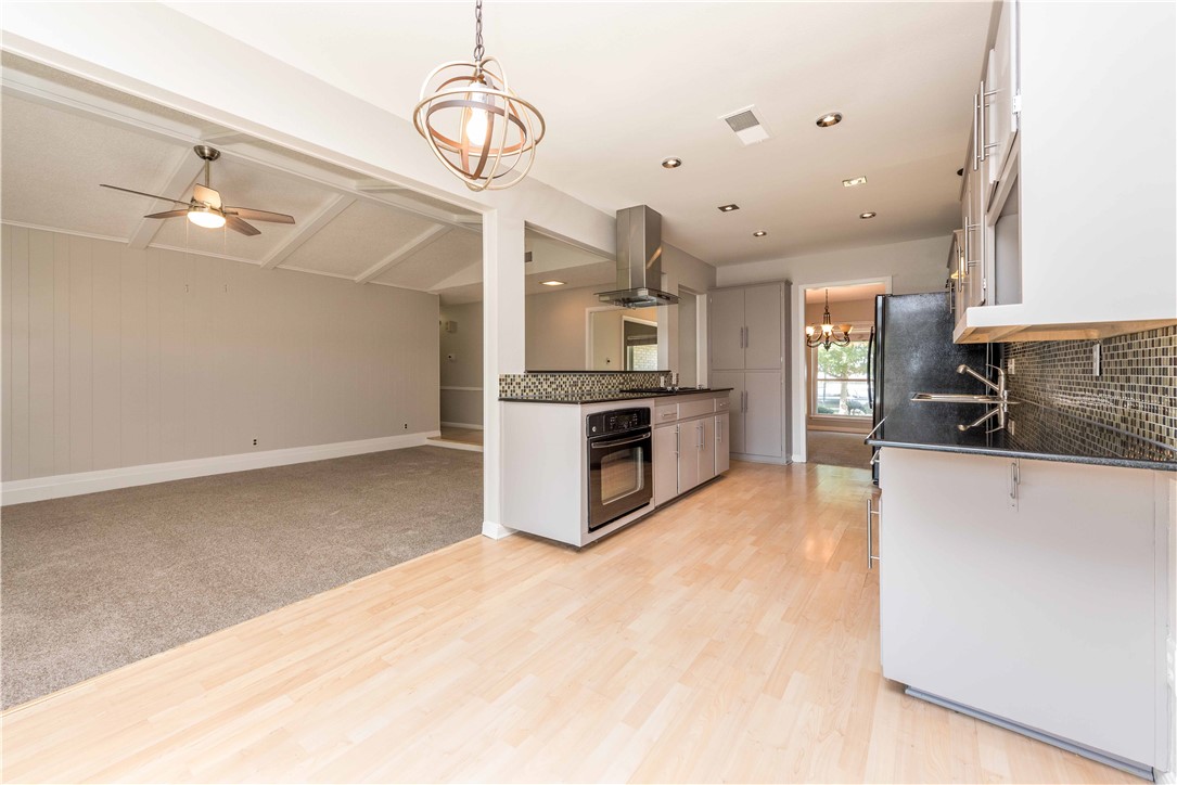 5505 Pendleton Lane Austin, TX 78723 - Photo 29 of 30 a large kitchen with stainless steel appliances kitchen island granite countertop a stove a sink and a refrigerator