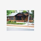 a picture of a bench in front of a house