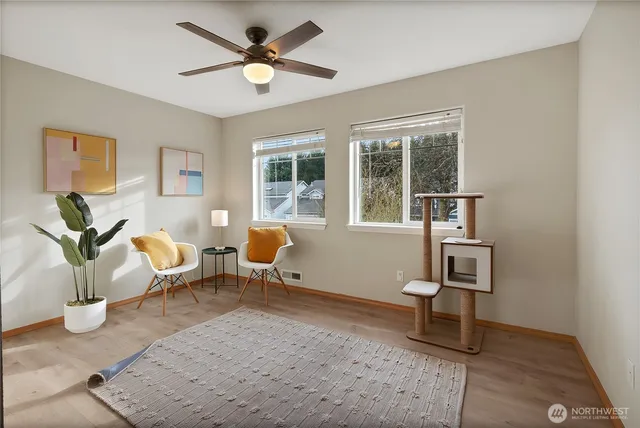 a living room with furniture a chandelier and a window