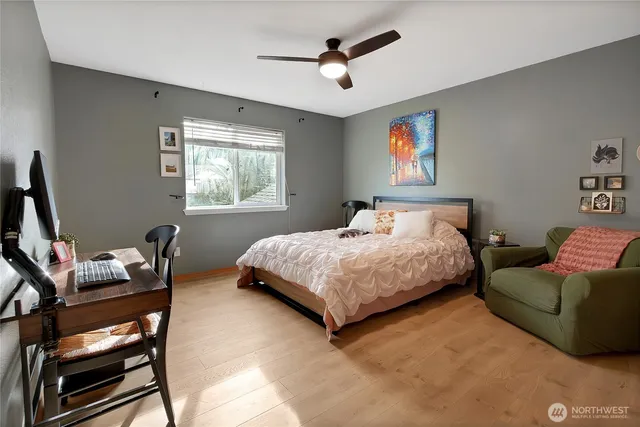 a bedroom with a bed a couch and a window