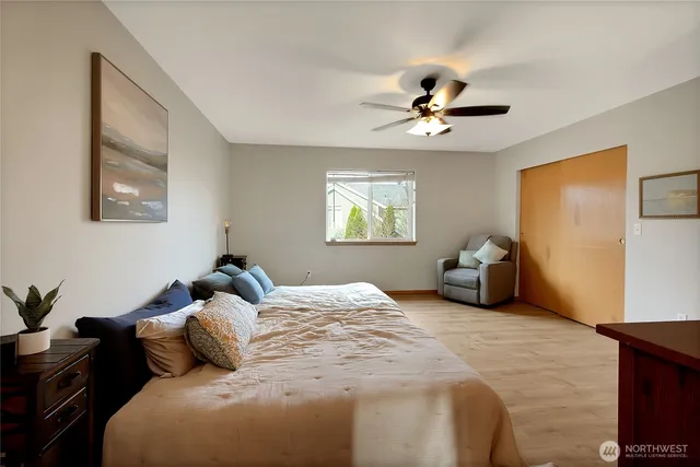 a bedroom with bed and a chandelier