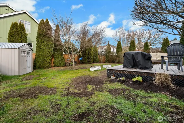 a view of a bench in a backyard of a house