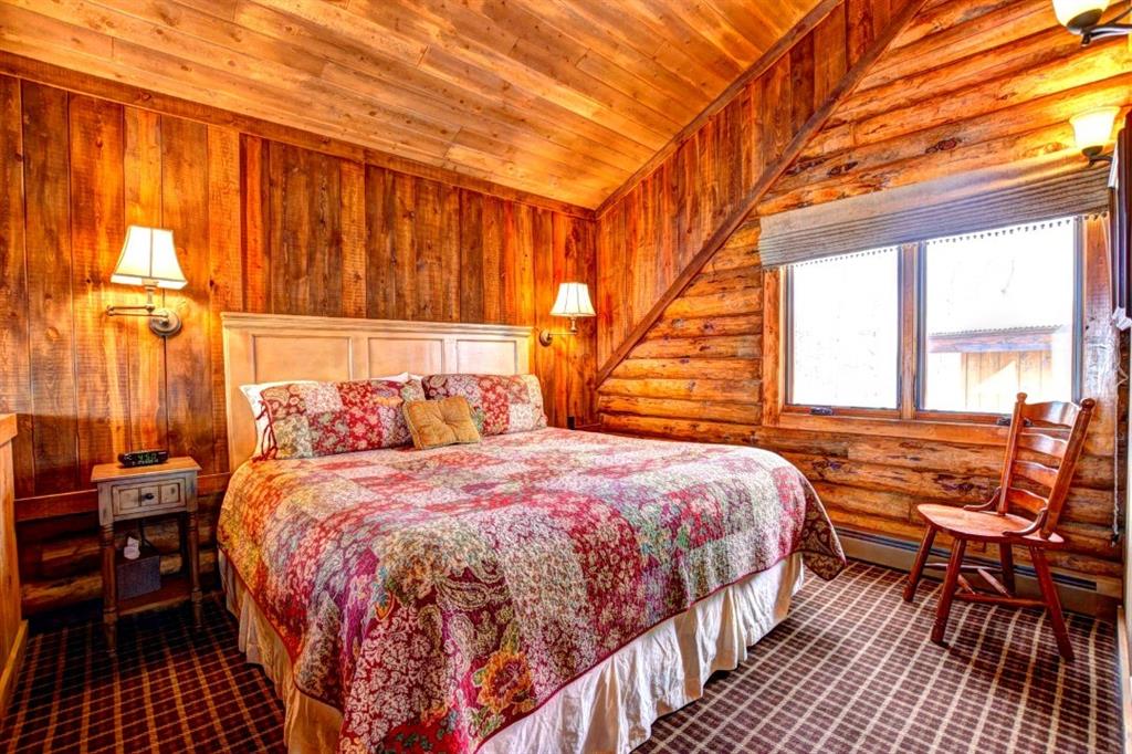 883 Osprey Road Como, CO 80432 - Photo 22 of 30 a bedroom with a bed and wooden floor
