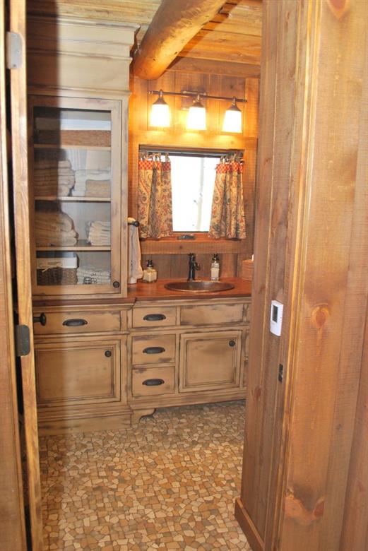 883 Osprey Road Como, CO 80432 - Photo 7 of 30 a bathroom with a granite countertop sink and a window