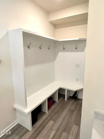 a hallway with table and wooden floors