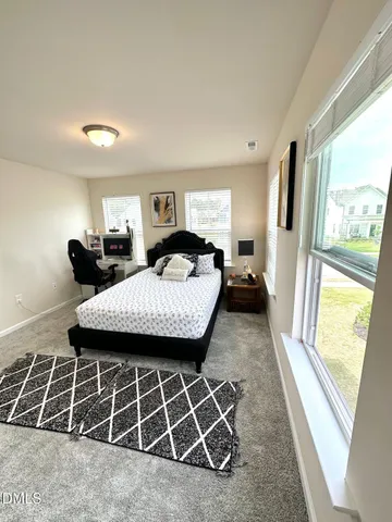 a bed room with a bed and a window