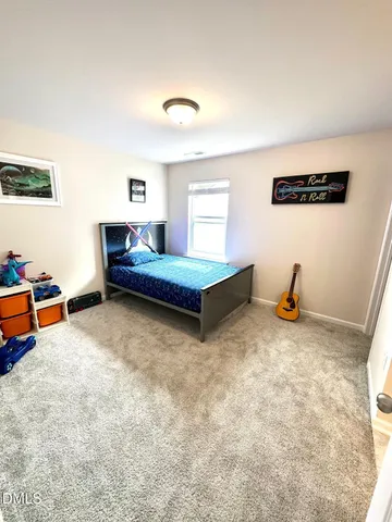 a bedroom with furniture and a rug