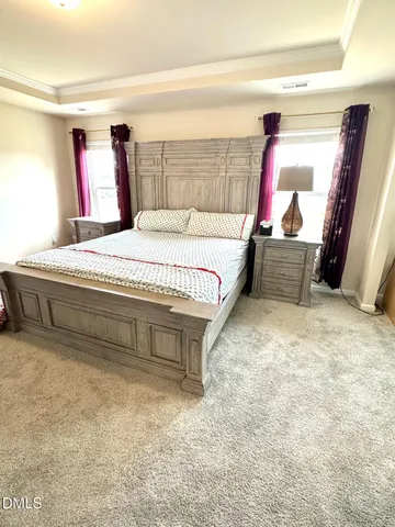 a bedroom with a bed and a couch