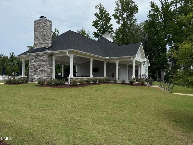 a view of swimming pool with outdoor seating and plants