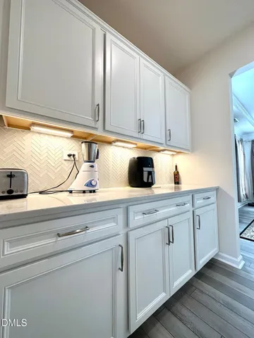 a kitchen with cabinets appliances a sink and a window