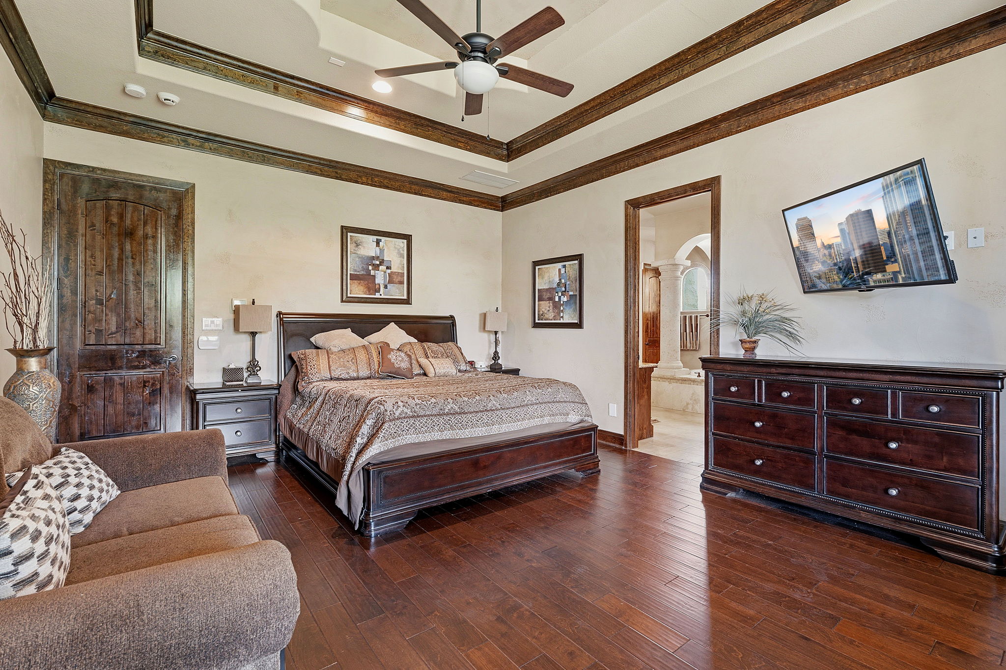 816 Brave Face Street Leander, TX 78641 - Photo 16 of 40 Rich hardwood floors complement the elegant crown molding and coffered ceiling in this well-appointed sleeping sanctuary.