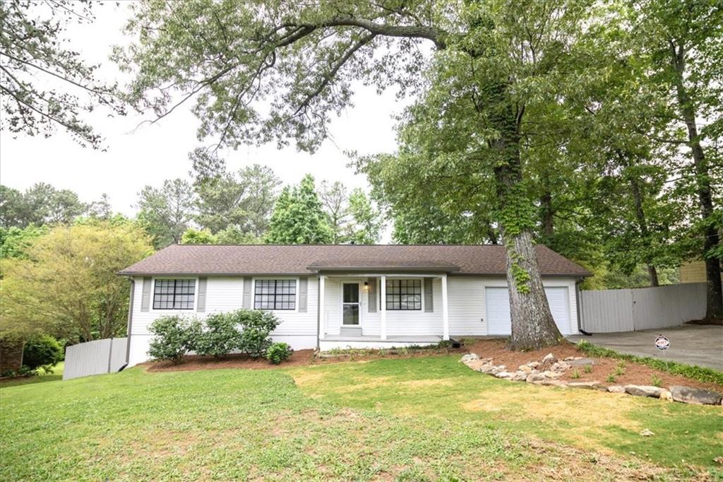322 Davis Road Stockbridge, GA 30281 - Photo 1 of 1 a view of a yard in front of a house with large tree