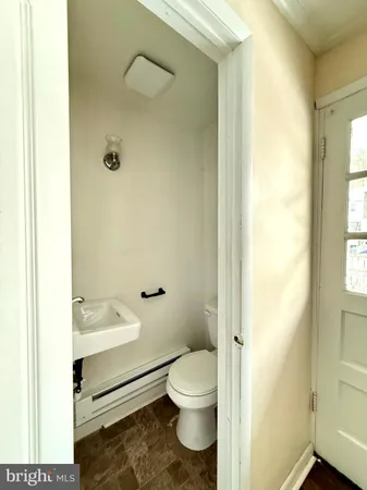 a bathroom with a granite countertop toilet and a shower