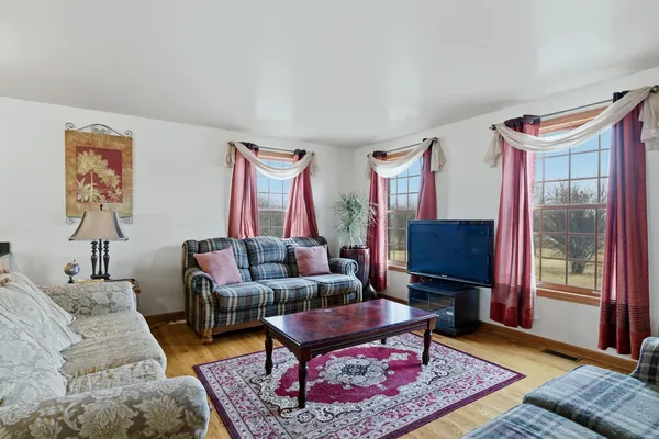 a living room with furniture a rug and a window
