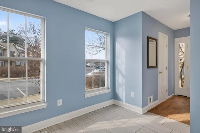 a view of a room with wooden floor and cabinets