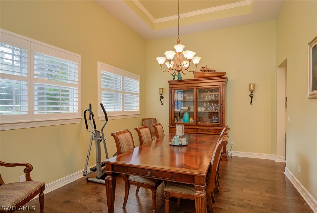4030 Staley Road Fort Myers, FL 33905 - Photo 12 of 35 a view of a dining room with furniture wooden floor and chandelier