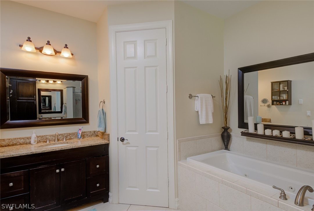 4030 Staley Road Fort Myers, FL 33905 - Photo 26 of 35 a bathroom with a sink vanity and mirror