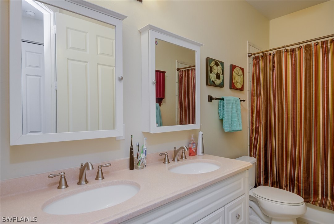 4030 Staley Road Fort Myers, FL 33905 - Photo 31 of 35 a bathroom with a sink a toilet and shower curtain