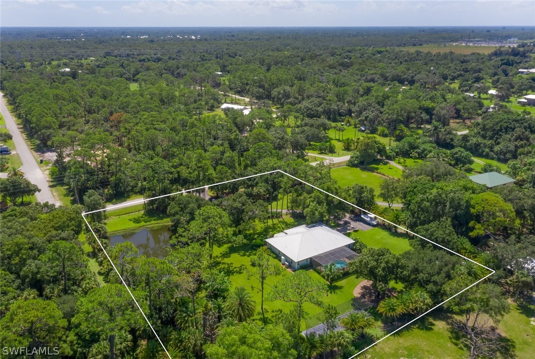 4030 Staley Road Fort Myers, FL 33905 - Photo 7 of 35 a view of a houses with a lush green forest
