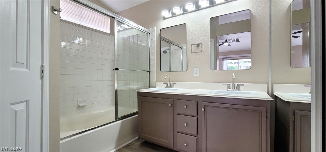 19 Rue De Parc Henderson, NV 89074 - Photo 9 of 23 Double vanities alongside a tiled shower and tub combination create a functional layout.