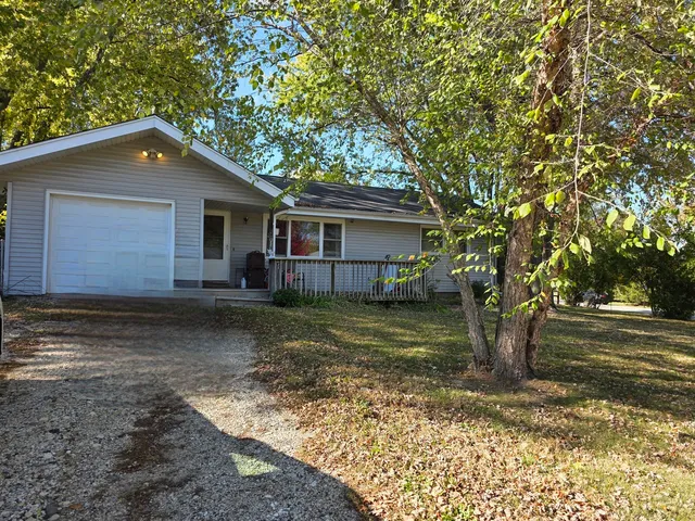 a house that has a tree in front of it