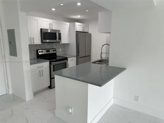 a kitchen with a sink a stove and refrigerator