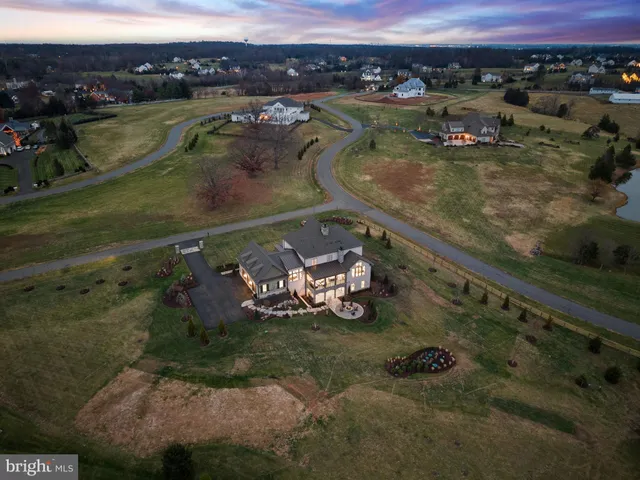 a view of a hallway view with living room and wooden floor