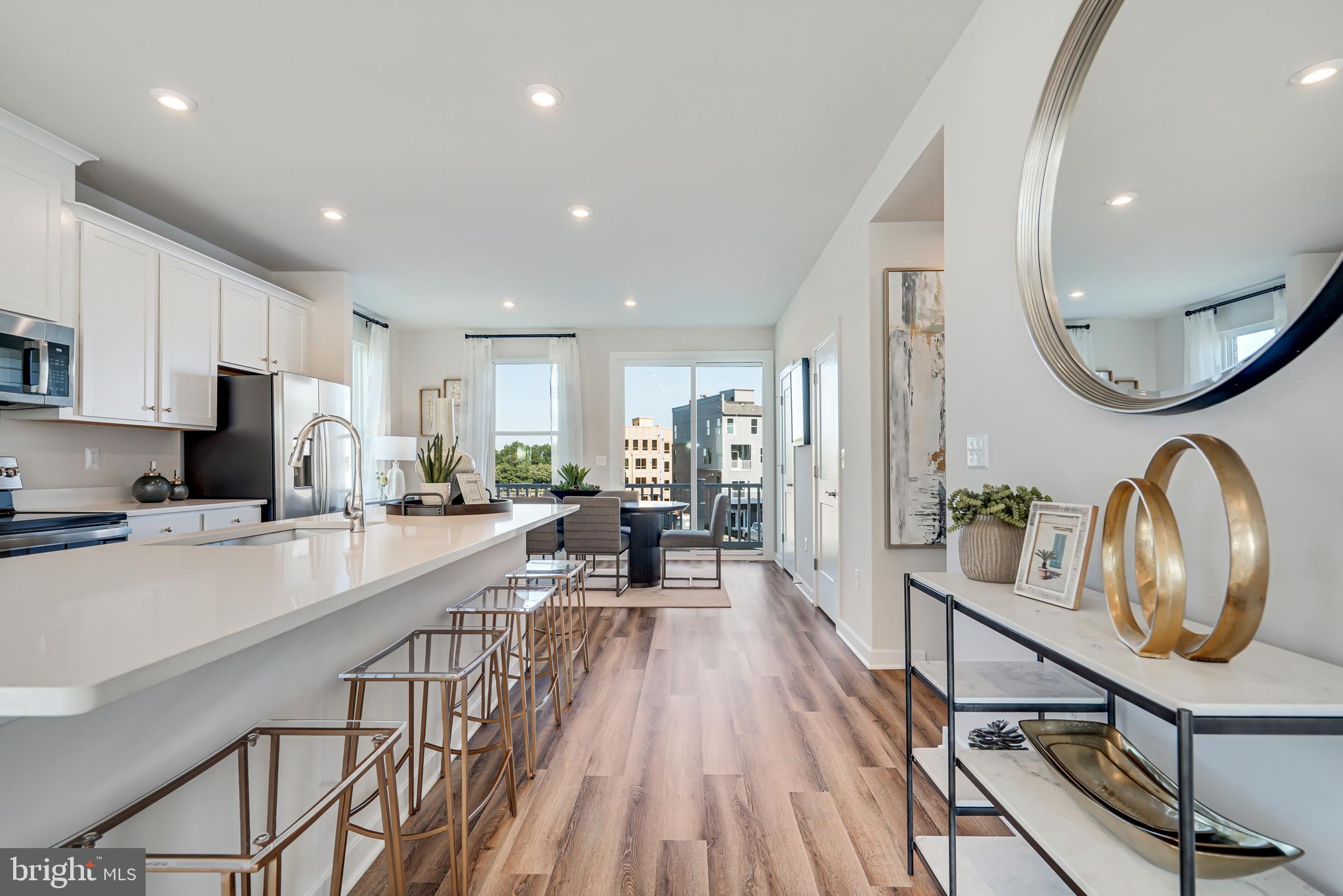 13658 Cobble Loop Woodbridge, VA 22193 - Photo 13 of 44 a very nice looking kitchen with kitchen island granite countertop lots of wooden cabinets a sink a stove a dining table and chairs