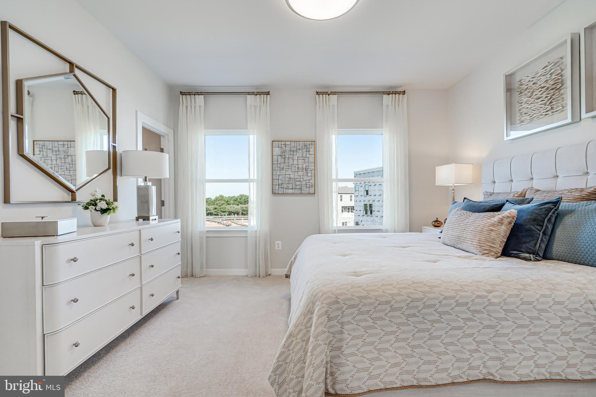 13658 Cobble Loop Woodbridge, VA 22193 - Photo 26 of 44 a spacious bedroom with a large bed and a window