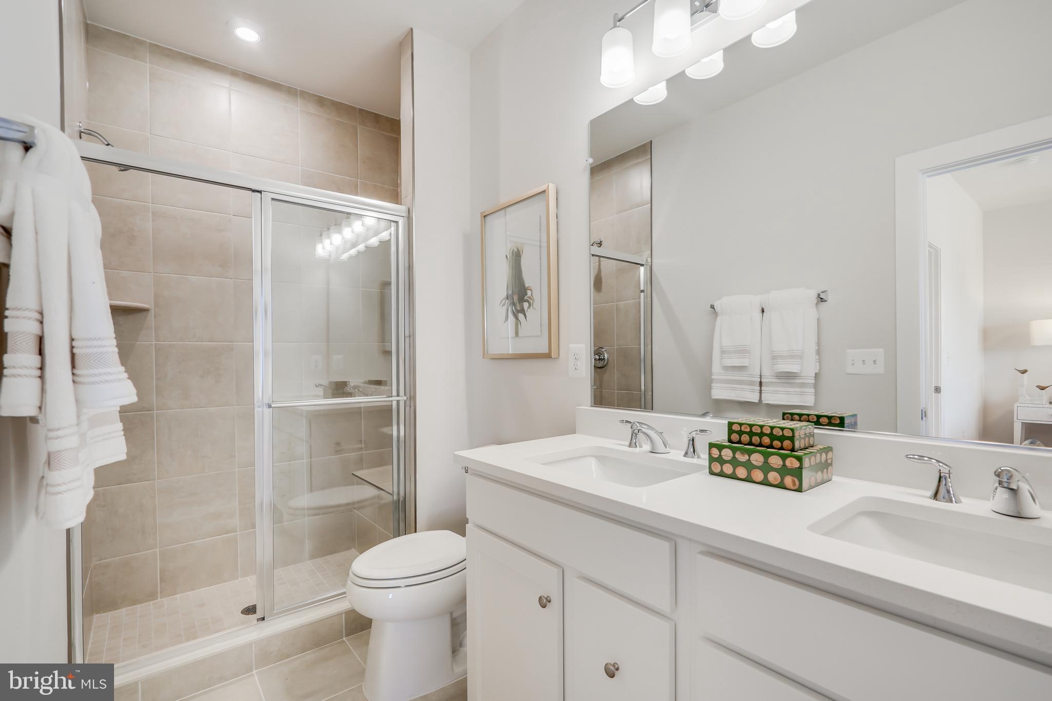13658 Cobble Loop Woodbridge, VA 22193 - Photo 29 of 44 a bathroom with a sink a toilet and shower