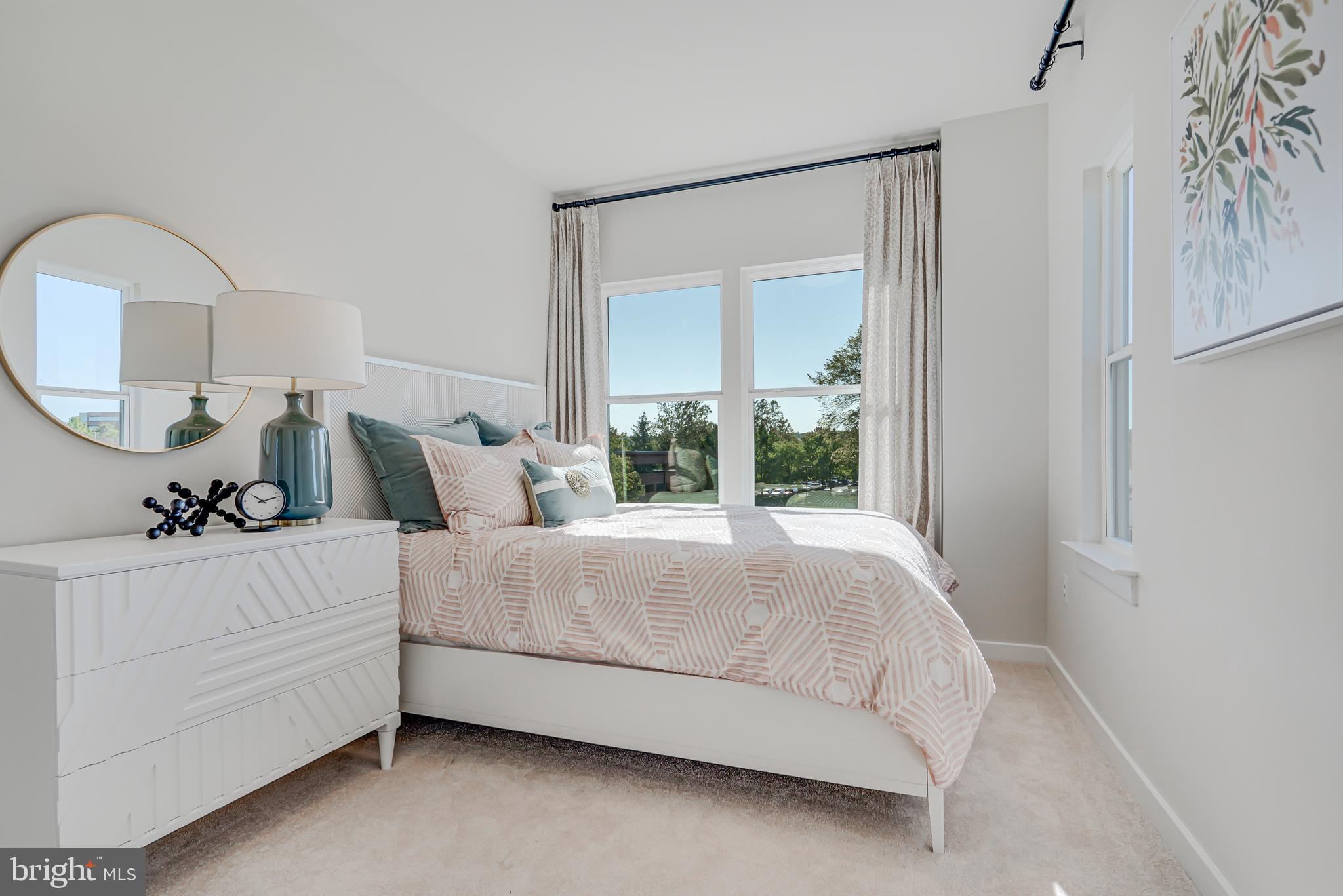 13658 Cobble Loop Woodbridge, VA 22193 - Photo 32 of 44 a bedroom with bed and a large mirror next to a window