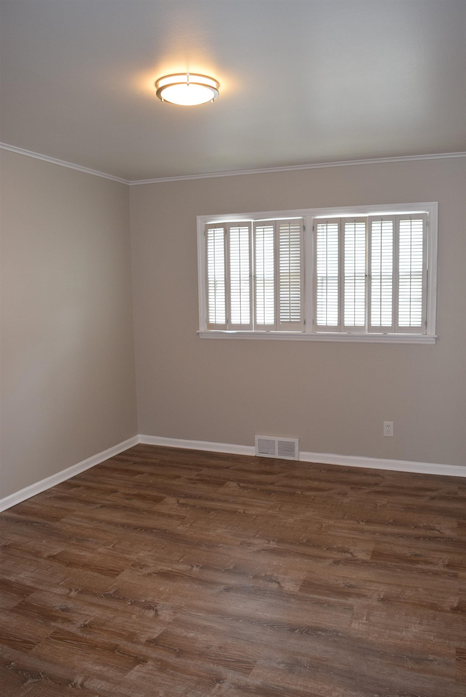 4144 Minden Road Memphis, TN 38117 - Photo 12 of 23 a view of an empty room with wooden floor and a window