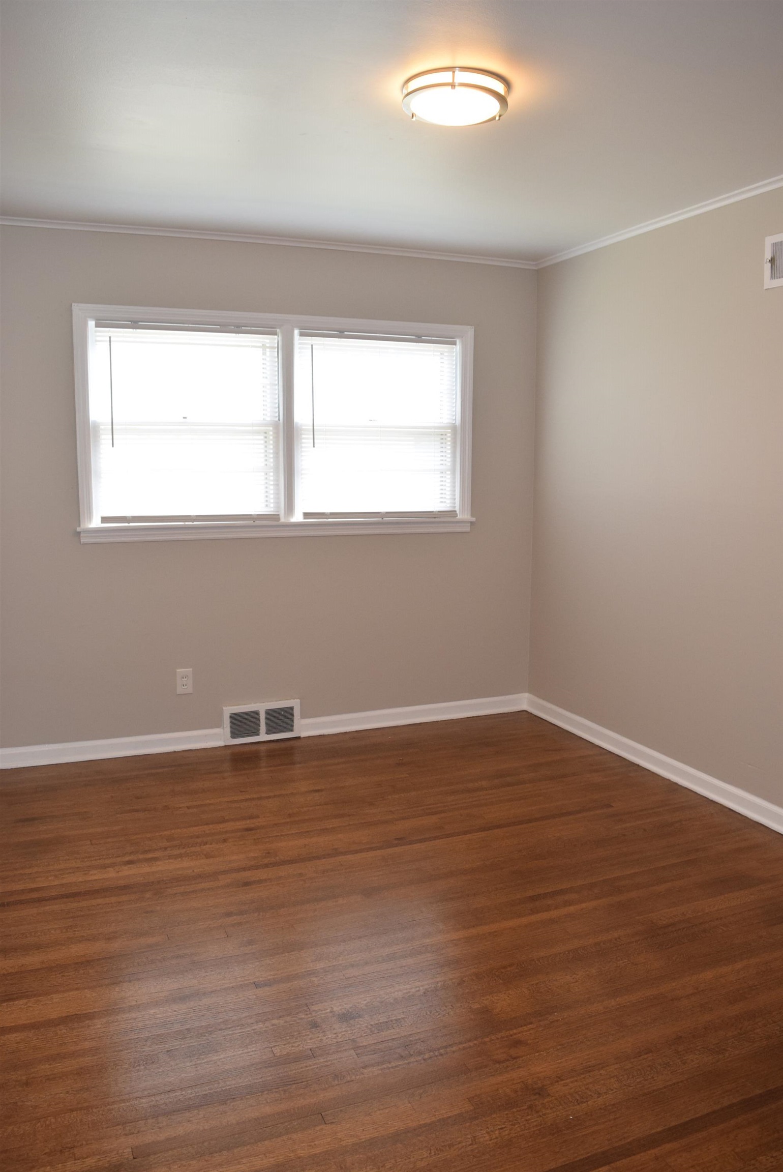 4144 Minden Road Memphis, TN 38117 - Photo 14 of 23 a view of an empty room with wooden floor and a window