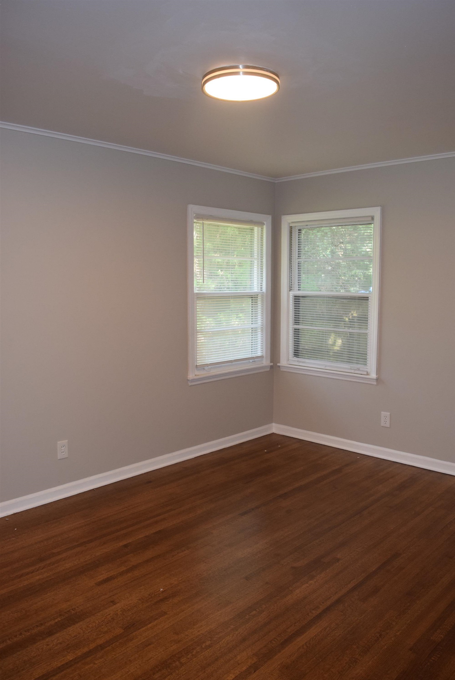 4144 Minden Road Memphis, TN 38117 - Photo 16 of 23 a view of an empty room with wooden floor and a window